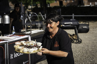 Frau serviert BBQ Fleisch @ 